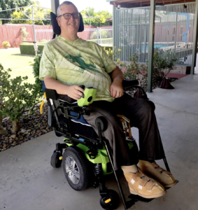 Power Mobility customer Michael sitting in his power wheelchair at his home in Bundaberg